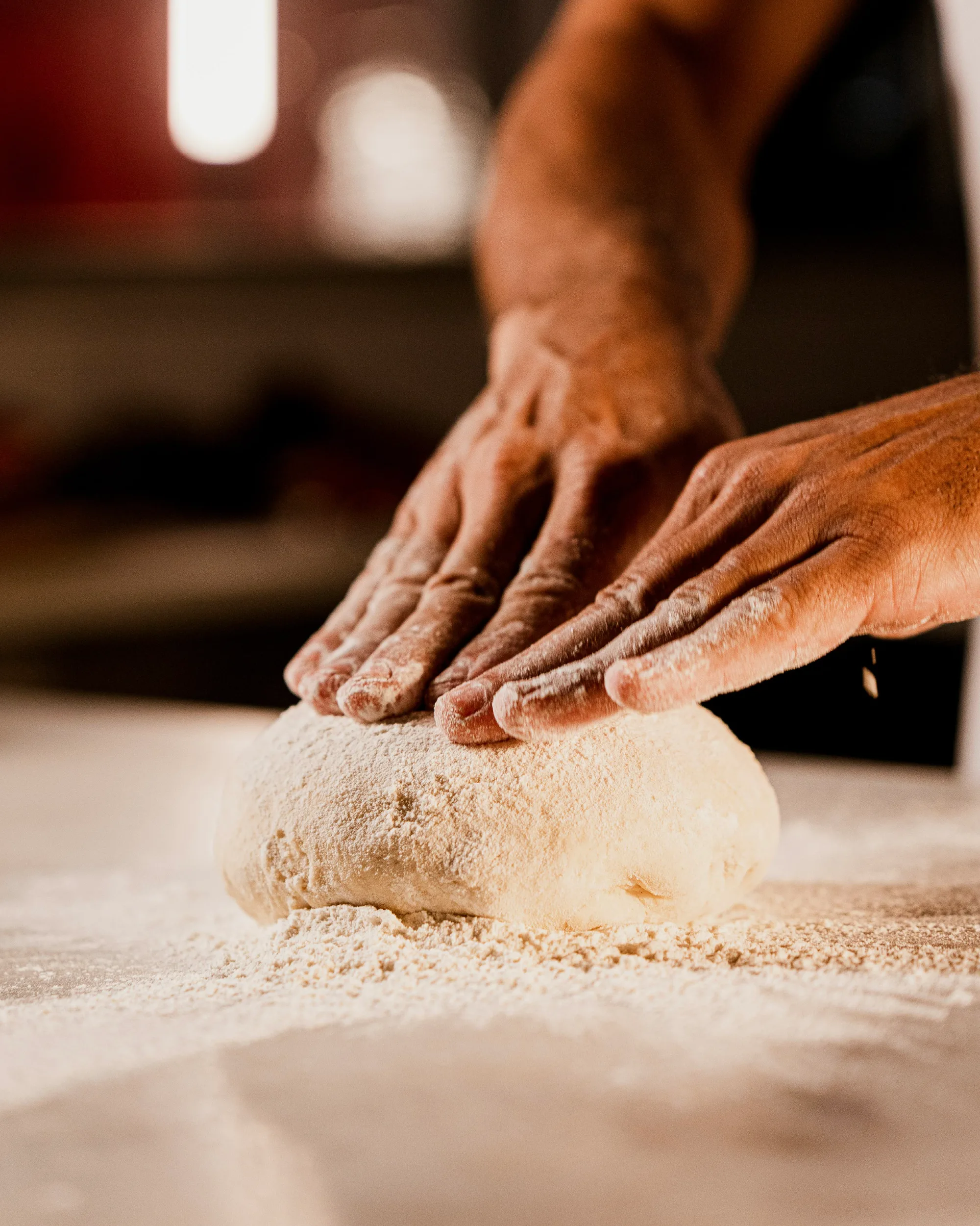 Dough being kneaded by hand in the Turmeric Co. kitchen